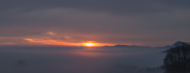 Winter sunset with inversion fog from valleys in Nemci village