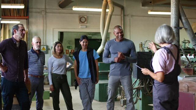 Female manager leading a team meeting in a carpentry workshop