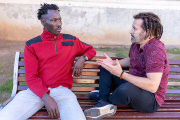 Two friends arguing on a park bench, having a serious conversation
