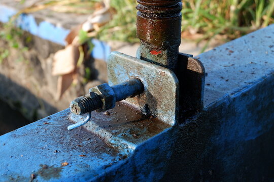 Industrial Blue Hydraulic Jack Screw On Rusty Metal Frame In Outdoor Setting