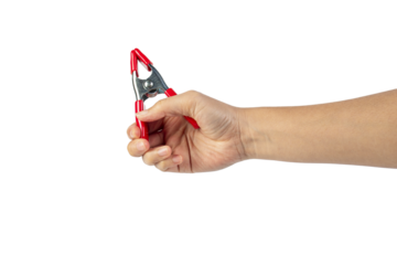 A studio shot of a red stainless spring clamp in hand isolated on a transparent background