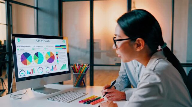 Team examines vibrant screen data, Discussion about A B testing and insights in office setting, Group reviewing colorful digital interface and charts during strategic analysis meeting in office