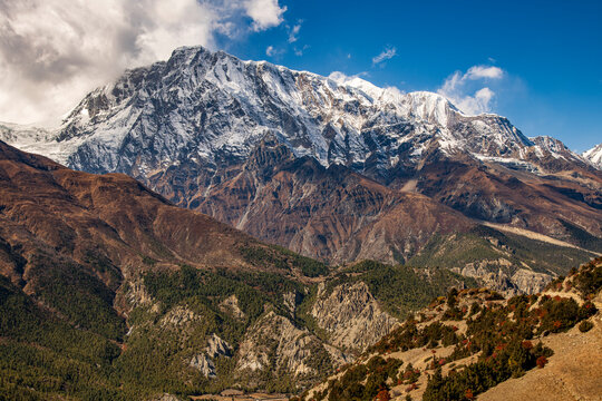 Mountain panorama of Gangapurna (7,455 meters) and Annapurna III (7,555 meters), photographed near Ghyaru village on the Annapurna Circuit on the way to Manang, Nepal. Dramatic Himalayan landscape.