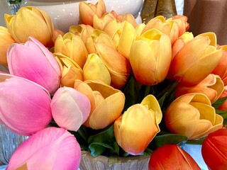 close up of a vibrant bouquet of pink orange and yellow tulips
