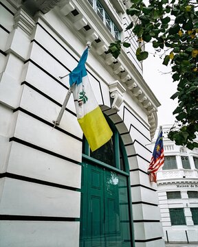 Malaysia, Penang - November 21, 2024 Flags at the UAB for United Asian Bank building in Georgetown.