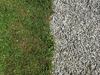 Contrast between light gravel and green grass with clear boundary. Copyspace