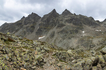 Obraz premium Hiking on the Smugglerpfad trail in Gargellen, Montafon, Vorarlberg, Austria during cloudy weather