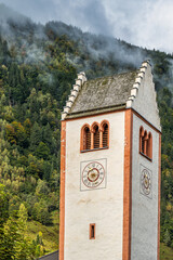Church tower with clock in alpine village of Fusch, Austria
