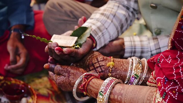 Authentic Indian marriage vidhi video showing traditional Hindu wedding rituals and sacred ceremonies. Features bride and groom performing wedding customs, Vedic rituals, priests, sacred fire (havan),