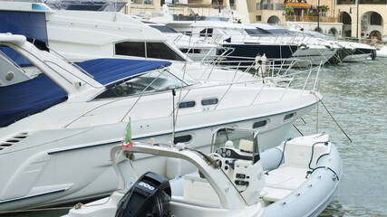 Marina Yachts and Motorboat Moored Along Waterfront Viewed in a Harbor