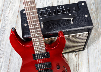 Red electric rock guitar and amplifier for music
