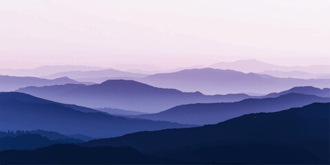 A misty blue morning fog blankets the mountain valley at sunrise as the sun glows over a scenic forest landscape of hills and clouds at dawn © ATIA