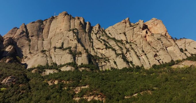 Montserrat's iconic saw-tooth peaks of Eocene conglomerate showcase geological drama framed by temperate Mediterranean vegetation, anchored by the ancient Santa Maria de Montserrat Abbey.