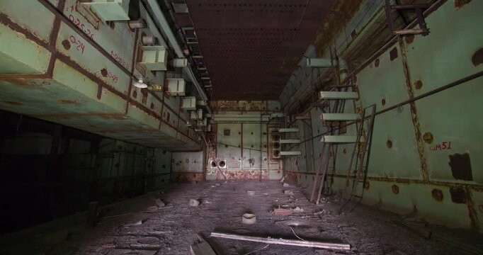 Explore the eerie, desolate interior of a Chernobyl reactor hall, a silent testament to a world-altering disaster.