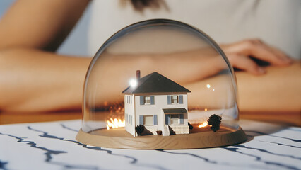 A protected house model under a glass dome, encircled by storms, waves, and flames, symbolizes 2026's rising climate risks, soaring insurance costs, and adaptation investments reshaping financial land