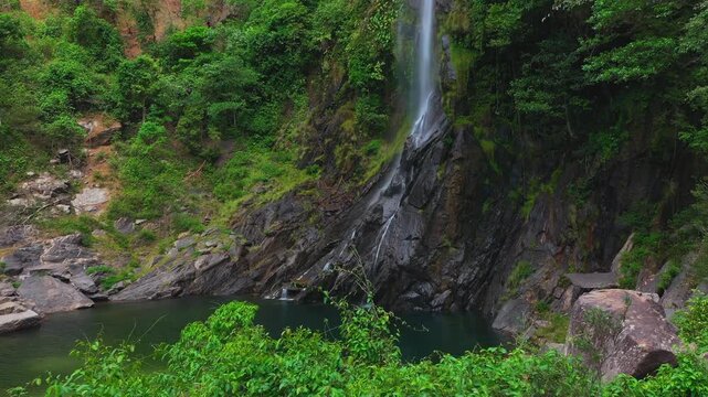 Cachoeira do Cato&aacute; Waterfall, located in the remote Campo Alegre district of Paran&atilde;, Tocantins, drone pull-out and then ascent showcasing vertical scale of the Serra do Mocambo and Rio Cato&aacute;, Brazil.