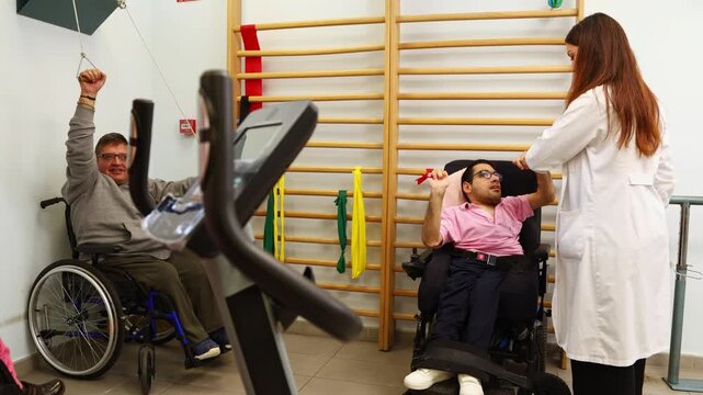 Disabled men in wheelchairs doing physical therapy exercises