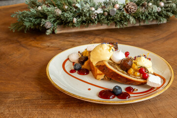 Gourmet dessert with fruit, cream and sweet bread on rustic table
