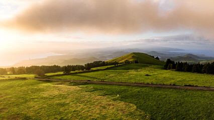 Sunset over green pastures, Azores islands, drone view. © Ayla Harbich