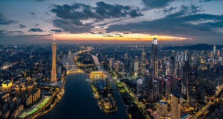 Fototapeta premium Aerial view of the modern city skyline and river at sunset in Guangzhou, China.