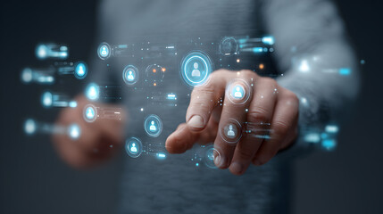 A person interacting with a futuristic digital interface with glowing blue icons