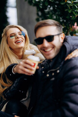 Unfocused foreground with joyful travelers during chilly coffee