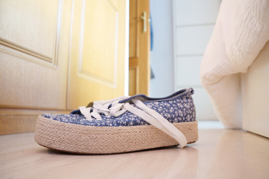 Casual morning scene, Cozy hallway setting with worn footwear and peaceful morning light