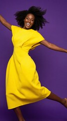 Energetic african woman in yellow dress against purple background