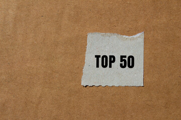 Top 50 message written on ripped torn paper background. Conceptual Top 50 symbol. Copy space.