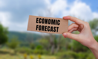 Economic Forecast message written on ripped torn paper background. Conceptual Economic Forecast symbol. Copy space.