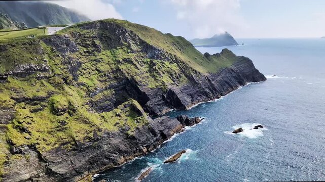 Kerry Cliffs, blue Atlantic Ocean and Skellig Islands on horyzon on a sunny summer day, Portmagee, Ring of Kerry, Ireland.	
