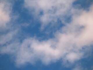 Obraz premium White clouds floating in a clear blue summer sky