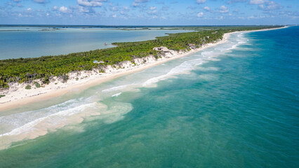 Sian Kaan Biosphere Mexico Beautiful beach with a blue ocean and a green forest in the background. The water is calm and the sky is clear