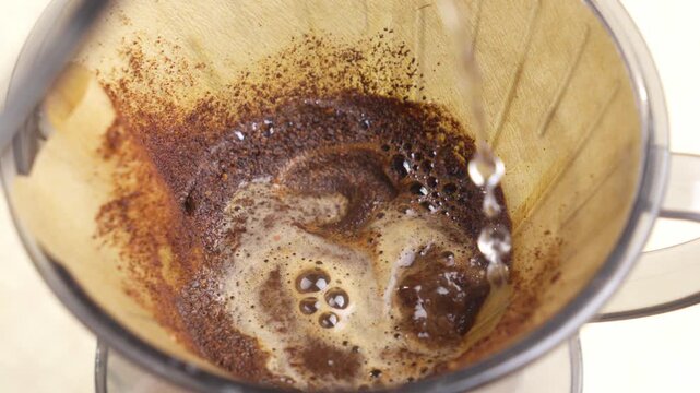Pour Over Coffee Brewing in Glass Dripper With Paper Filter, Hot Water Pour, Top View