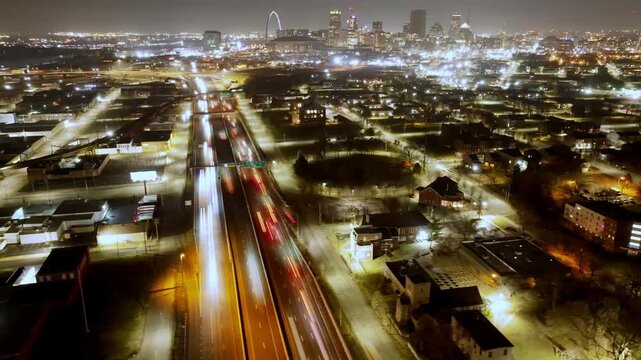 Time lapse view of traffic moving left to right over Interstate 70 in St Louis Missouri. Urban highway transportation scene showing city infrastructure and commuter flow.