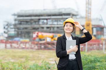 Confident female engineer overseeing industrial plant operations, working closely with her company to align engineering processes with business strategy and modern industry standards.