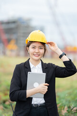 Female engineer supervising an industrial power plant project, collaborating with her company team to support business continuity, safety compliance, and efficient machinery management.