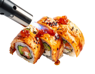 Close-up of sushi rolls being torched with a culinary torch.