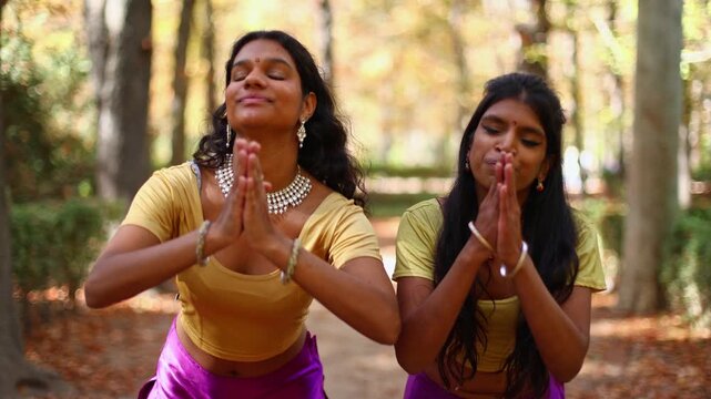 Two young indian women performing traditional bollywood dance