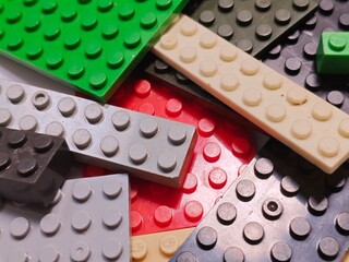 Fototapeta premium Assorted Colored Plastic Building Blocks Closeup.