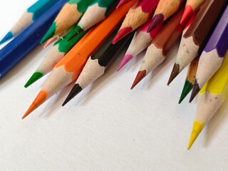 Colorful Pencils Arranged on White Surface.