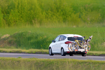 Bikes attached to automobile rear carrier for vacation