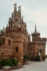 Historic monument blending diverse architectural styles, featuring ornate towers and intricate stonework in Benalmadena, Spain, captured to highlight its cultural significance and unique design