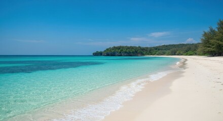 Fototapeta premium Idyllic tropical beach with clear turquoise water lapping a white sandy shore, under a bright blue sky