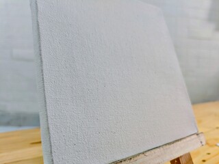 White Blank Canvas on Wooden Table.