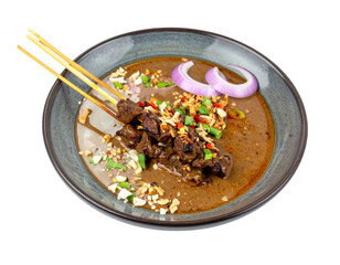 Delicious Beef Satay Skewers with Peanut Sauce and Garnishes.
