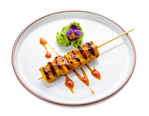 Delicious Chicken Satay Skewers with Peanut Sauce and Garnish.