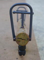 Children's swing made of logs and metal