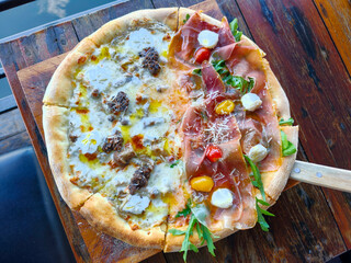 Two sided pizza Truffle and mushroom, Sliced ​​pork. Top view of Italian food