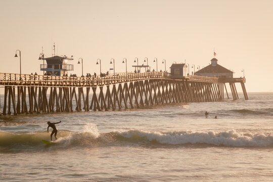Surfer at the pier in Imperial Beach, California